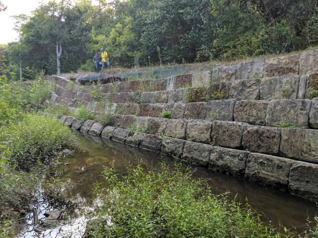 an eroding retaining wall along a creek